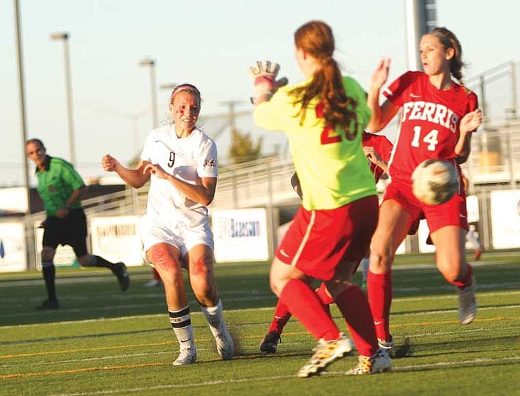 Moses Lake senior forward Alysha Overland, 9, scores past Ferris freshman goalkeeper Evan Watkins, 25, and senior defender Maison Stults, 14, in the second half Saturday, Sept. 20, at Lions Field.