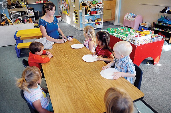 &lt;p&gt;Amy Joy writes names on the plates of the 2 to 3 year old
students in her Early Learning Center class on Friday morning at
Saint Matthew's.&lt;/p&gt;