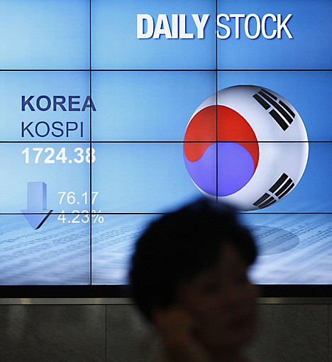 &lt;p&gt;A woman uses her mobile phone in front of a screen showing the falling Korea Composite Stock Price Index (KOSPI) at Mirae Asset building in Seoul, South Korea, Friday, Sept. 23, 2011. Asian stocks faced sharp losses early Friday following a precipitous session of trading of Wall Street sparked by fears that a global recession may already be under way. (AP Photo/Lee Jin-man)&lt;/p&gt;