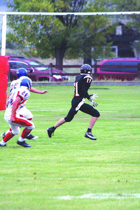 Senior runningback Taylor Firestone breaks free from two defenders on an out route.