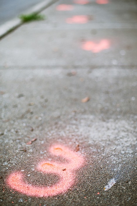 &lt;p&gt;A light spot in the concrete near a detective's marking indicates one of a string of bullets that ricocheted off the sidewalk near the Coeur d'Alene Manor apartment complex for seniors and disabled residents.&lt;/p&gt;
