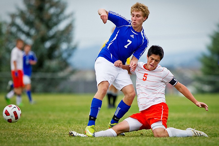 &lt;p&gt;Post Falls High's Scott Benner slides in front of Adam Broshiem from Coeur d'Alene to knock the ball away during the first half of Thursday's game.&lt;/p&gt;