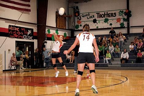 Jason Shueh/Valley Press Senior Kylee Knudson, left, saves a precarious volley from Mission&#146;s Lady Bulldogs as Emma Ehret prepares to assist.