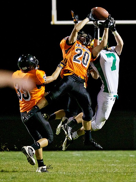 <p>Post Falls High's Tyler Morris elevates in front of Troy Carr from Lakeland High to break up a long pass play Friday during the first half of the Trojan's 42-14 win over the Hawks.</p>