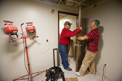 &lt;p&gt;Congregation members Don Roper, right, and Roger Schwartz work on the installation of a window in a door.&lt;/p&gt;