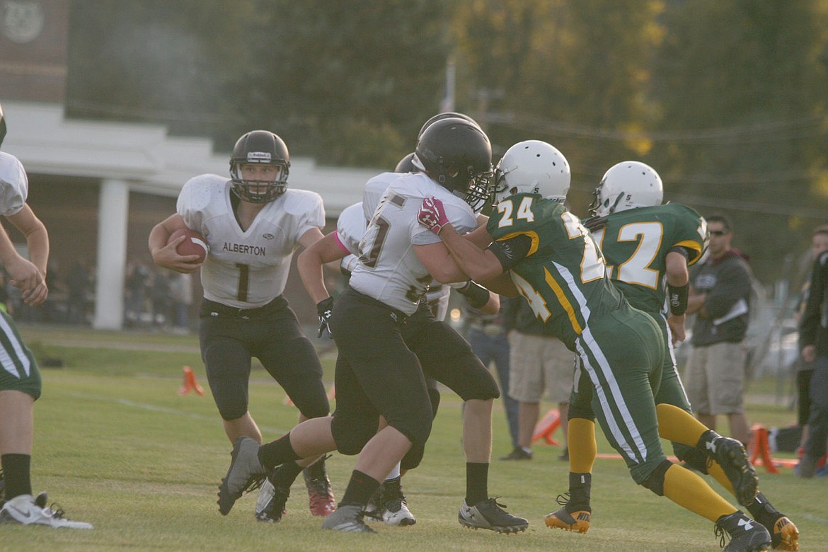 &lt;p&gt;Panther quarterback Jack Lehl, left wearing #1, goes for one of his many rushes against the St. Regis Tigers last Friday. Alberton won the rematch 91-56.&lt;/p&gt;