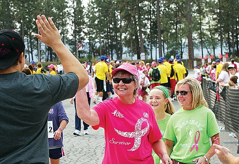 &lt;p&gt;Wilma Westlund, 73, who beat the disease 20 years ago, prepares for a high-five from North Idaho College wrestler and race day volunteer Bryan Smith Sunday at the finish line of the North Idaho Race for the Cure fun run.&lt;/p&gt;