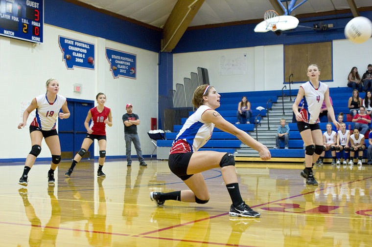 <p>Superior senior Michele Smith goes low for a dig against Lincoln on Saturday night.</p>