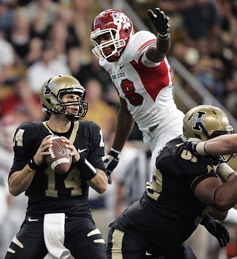 <p>Fresno State defensive lineman Tristan Okpalaugo jumps over a blocker to sack Idaho quarterback Brian Reader during the second half Saturday in Moscow.</p>