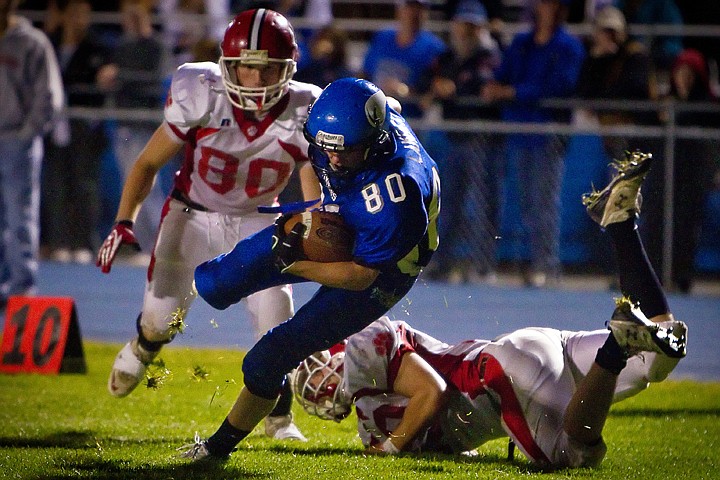 &lt;p&gt;Coeur d'Alene High's Matt Lambert pivots as he heads upfield after evading Sandpoint defenders Joe Duarte, left, and Luther Morgan. Lambert eventually made his way into the end zone after powering through one more defender.&lt;/p&gt;