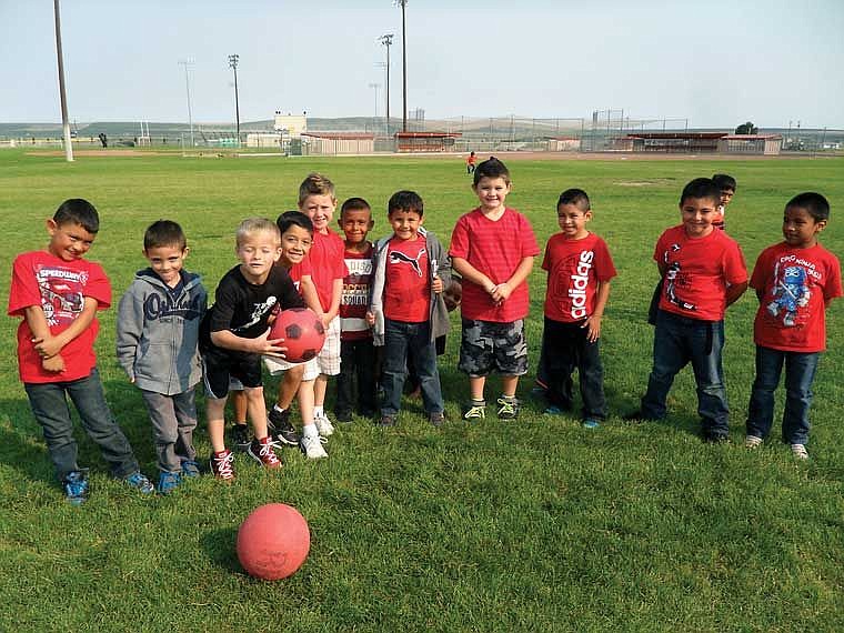 First grade boys wearing red in support of the color of the day during Kindergarten Color Week.