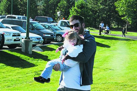 &lt;p&gt;Brice Klein, of Seattle, carries his niece, four-year-old Claire Leitz, during Saturday's Ds Connections Northwest Buddy Walk at Riverstone Park.&lt;/p&gt;