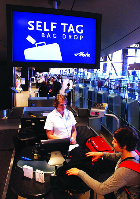 &lt;p&gt;In this June 25 photo, a customer drops off her bag at Seattle-Tacoma International Airport in Seattle.&lt;/p&gt;