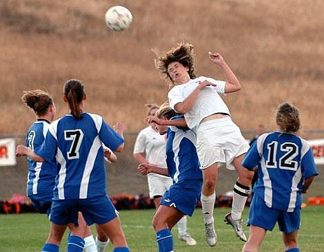 Flathead High School&#146;s Meghan O&#146;Connell attempts a shot on goal while heading the ball above several Missoula Big Sky defenders on a corner kick late in the second half at Kidsports Complex in Kalispell on Tuesday. Flathead tied Missoula Big Sky, 2-2. Garrett Cheen/Daily Inter Lake