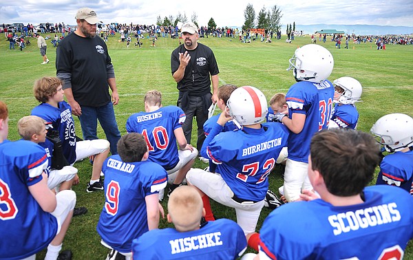 Todd Morrison, left, and head coach Matt Sillivan giving the Bigfork Vikings a half time pep talk on Saturday during the opening weekend of Little Guy football.