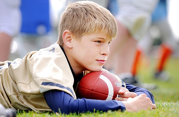 Billy Droskoski, 11, of the Tire-Rama team from Columbia Falls watches from the sidelines on Saturday during the opening weekend of Little Guy football.