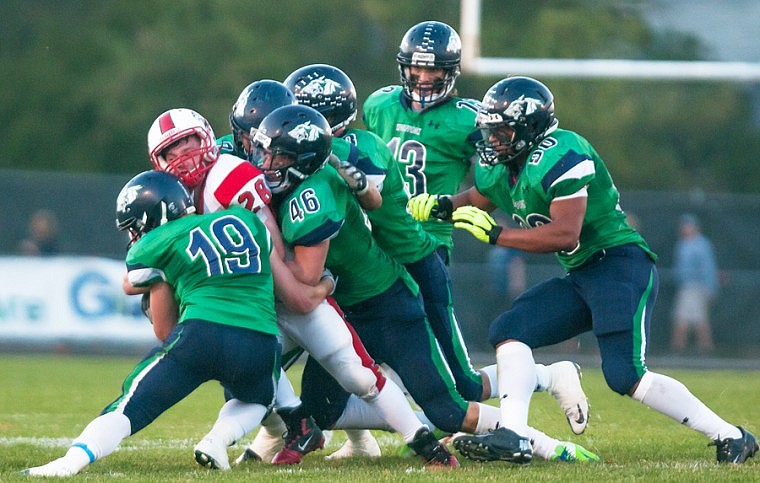 &lt;p&gt;Patrick Cote/Daily Inter Lake Glacier defenders Dawson Day (19), Shelton Todd (46) and others stop Bozeman running back Hunter Gappmayer (28) Friday night during the Wolfpack's 7-3 homecoming victory over No. 1 ranked Bozeman at Legends Stadium. Friday, Sept. 21, 2012 in Kalispell, Montana.&lt;/p&gt;