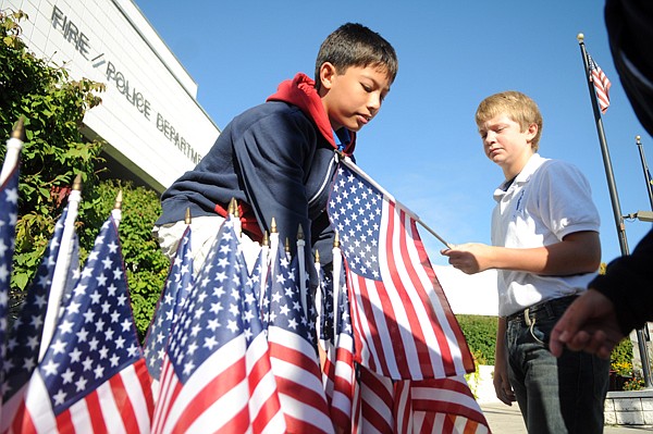 &lt;p&gt;Conner Masur, left, and Robert McCarvel, both students at Saint
Matthew's, remove flags from the memorial outside the Kalispell
Fire Department. On Friday, September 9th, staff and students from
Saint Matt's along with law enforcement and emergency responders
marched 343 flags to the fire departmetn in honor of the first
responders who died in the 9/11 terrorist attacks. According to
Dominick Kovacevic the flags were to be taken down last week but
the fire department asked if they could keep the memorial up a
while longer as people were still stopping by on a regular
basis.&lt;/p&gt;