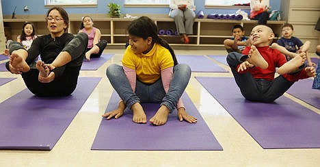 &lt;p&gt;Crockett Elementary Health and Wellness instructor Morgan Camp, left, leads a pose with students Darait Rodriguez, center, Angel Benito right, and others during a Yoga class, Sept. 19.&lt;/p&gt;