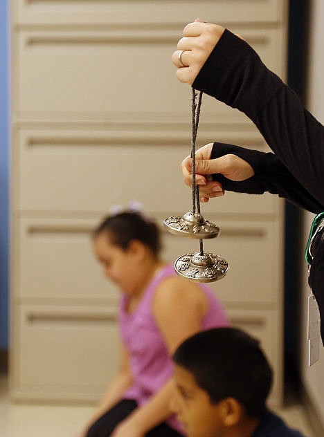 &lt;p&gt;Crockett Elementary Health and Wellness instructor Morgan Camp rings a set of bells for students to prepare for Yoga class, Sept. 19.&lt;/p&gt;