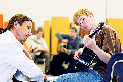 &lt;p&gt;Taylor Arveson, a ninth grade student at New Vision High School in Post Falls, plays notes on a guitar as classical guitarist Brad Richter coaches him through a scale during a 2012 workshop.&lt;/p&gt;