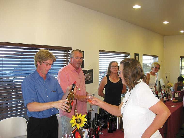 Brett Schrom, SHOC president who poured for Camas Cove Cellars, Pete Beaumont of Beaumont Cellars and Katie Beaumont visit with Amy Jo Para. Katie is the fomer Katie Lee of Royal City. Rhonda Davis of Foxy Roxy Winery is in the background.