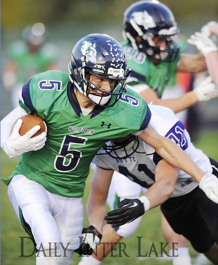 <p>The Wolfpack's Devin Cochran attempts to break a tackle after hauling in a pass during the first quarter against Butte on Friday. (Aaric Bryan/Daily Inter Lake)</p>