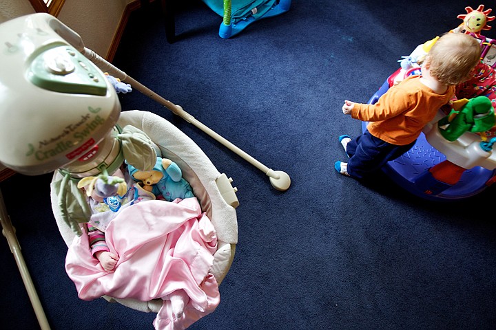 &lt;p&gt;JEROME A. POLLOS/Press An infant sleeps in a cradle while as another child plays in the living room of one of the Children's Village homes Monday in Coeur d'Alene. The facility is seeing an increase in children dropped off to their crisis nursery which is putting increased financial pressure on the nonprofit.&lt;/p&gt;