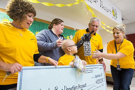 &lt;p&gt;Assistant principal at Ramsey Magnet School Crystal Kubista, far right, presents first-grader Landon Burt and his family with a donation and gifts. From left is grandmother Wendy Devenere, mother Tracy Burt, Landon Burt, grandfather Denny Burt and Crystal Kubista.&lt;/p&gt;