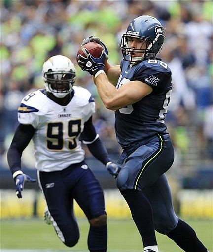 Seattle Seahawks' John Carlson, right, makes a catch as San Diego Chargers' Kevin Burnett gives chase in the first half of an NFL football game, Sunday, Sept. 26, 2010, in Seattle. The Seahawks won 27-20. (AP Photo/Elaine Thompson)