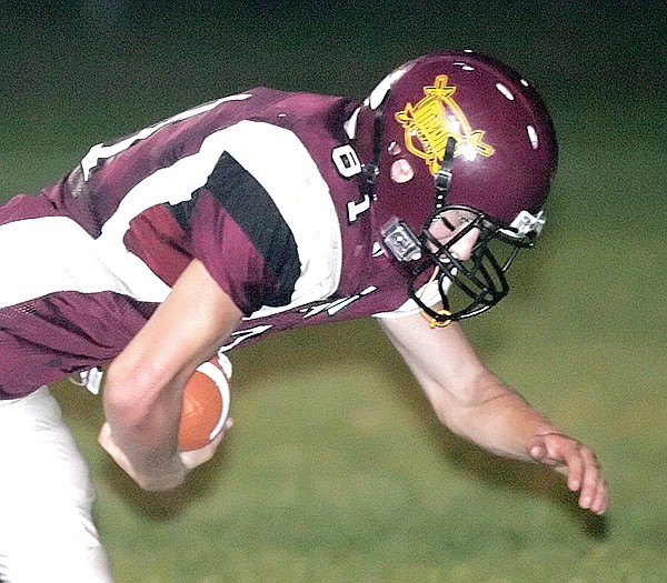 Troy's Tommy Nyland leaps into the end zone for a TD in the third quarter vs. Plains.