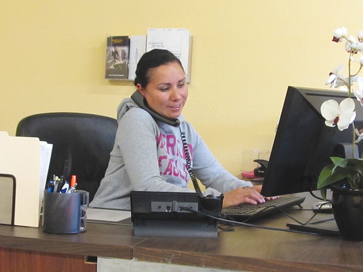 Sandra Pavon, who heads up the family business, Pavon
Satellites, assists a customer over the phone from the store in
Mattawa