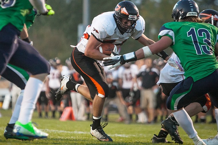 &lt;p&gt;Flathead senior running back Austin Root (center) eyes the goal line Friday night during the sixth crosstown matchup at Legends Stadium.&lt;/p&gt;