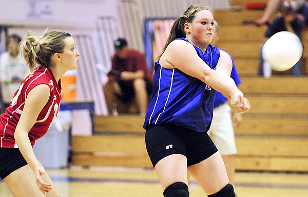 Columbia Falls senior Erin Hill (center) returns a serve during the first game against Ronan on Thursday evening.