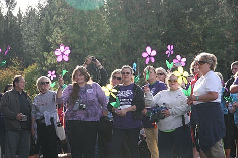 &lt;p&gt;Several people lift their purple Promise Garden flowers as they honor lost loved ones at the 2014 Walk to End Alzheimer's on Sunday morning in McEuen Park.&lt;/p&gt;