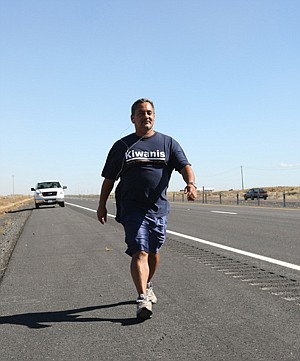 Louis is walking near Dodson Road on Interstate 90. He received an exception from the Washington State Transportation department to walk on the shoulders of I-90. Tom Heath, a local Kiwanian, followed in the escort vehicle to provide refreshments and support if necessary.