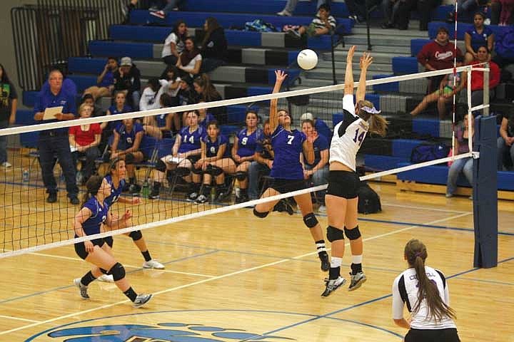 Outside hitter Shania Kisler (7) goes for the spike against senior middle blocker Kylie Booker (14).