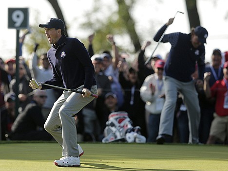 &lt;p&gt;USA's Keegan Bradley and Phil Mickelson, background, react after Bradley made a putt on the ninth hole during a Ryder Cup foursomes match Saturday at Medinah, Ill.&lt;/p&gt;