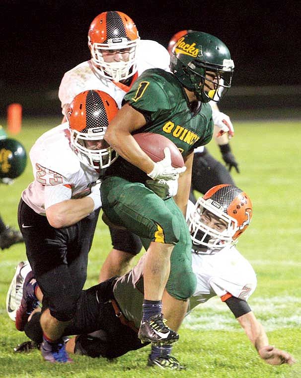 Quincy running back Andy Vargas, 1, is unable to elude Ephrata tacklers during the Battle of the Basin Friday, Sept. 26, at Jaycee Stadium.