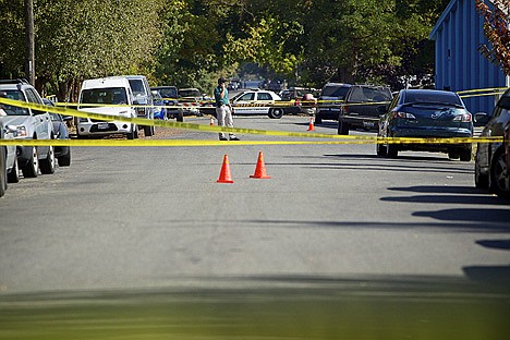 &lt;p&gt;A law enforcement officer talks on his phone while at the scene of a shooting Saturday at Lakeside Avenue and 12th Street in Coeur d'Alene. One person was shot in the chest and the suspect led police on a pursuit toward Higgens Point where he fired upon officers and was shot and killed.&lt;/p&gt;