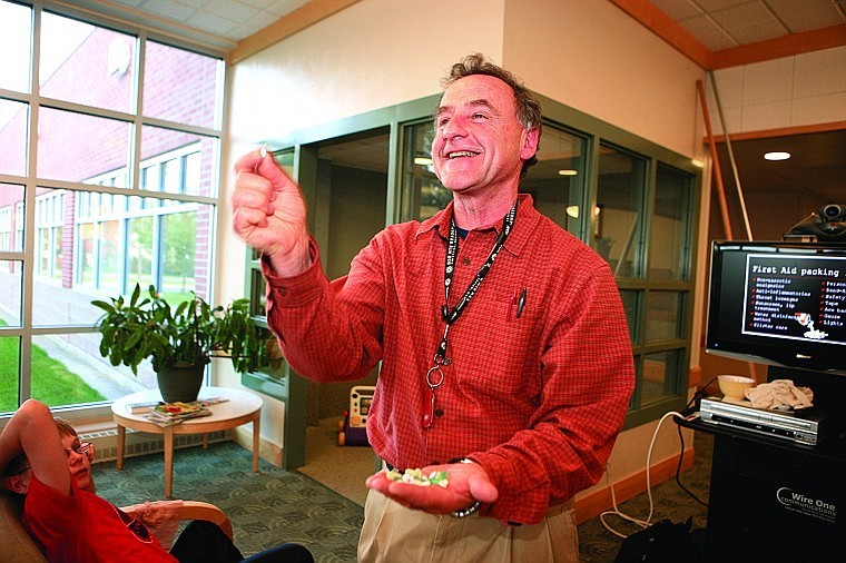 Dr. Michael Righetti, orthopedic surgeon and backcountry horse riding enthusiast led the wilderness first aid seminar at St. Joseph's Medical Center Sept. 15. Righetti shows the audience each of his many-colored pills, which he keeps in one bottle in his first aid kit. The trick, he says while laughing, is to remember what they all do when you need them.