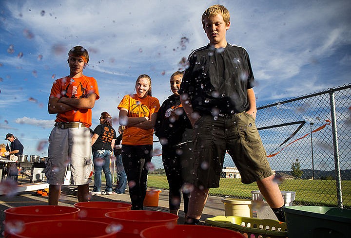 &lt;p&gt;TESS FREEMAN/Press&lt;/p&gt;&lt;p&gt;From left: Carsen Daughenbaugh, Kayla Mayo, Sammie Schumacker, and Terran Sharbrouth supervise the water balloon toss, a fundraiser for the Trojans football team, during the Post Fall tailgate for their homecoming game against East Valley on Friday night.&lt;/p&gt;