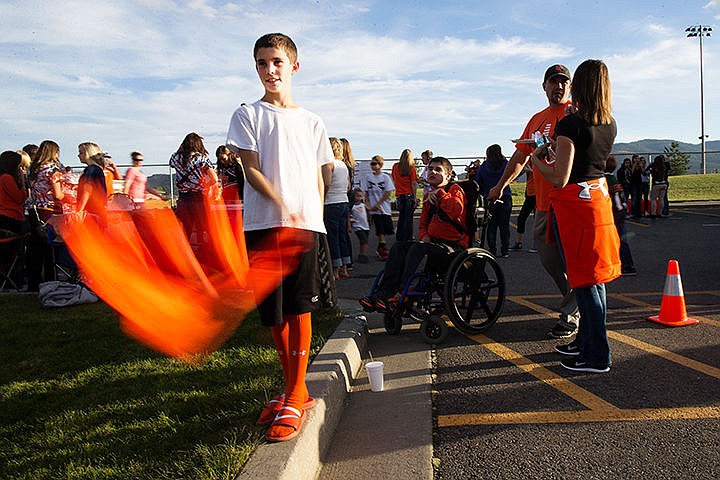 &lt;p&gt;TESS FREEMAN/Press&lt;/p&gt;&lt;p&gt;Nolan Lyons, 10, wave hiis Trojans football jersey during the Post Falls High School tailgate on Friday evening before the Post Falls homecoming game. Lyons has two brothers on the Trojans varsity and junior varsity football team he came to support on Friday night.&lt;/p&gt;