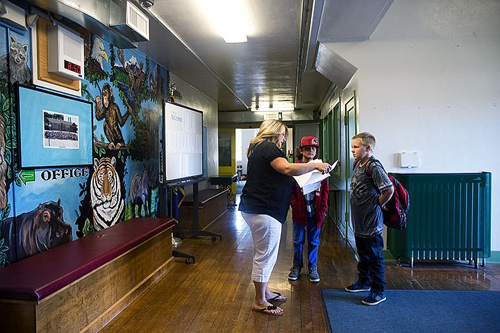 &lt;p&gt;TESS FREEMAN/Press&lt;/p&gt;&lt;p&gt;Fifth graders Lance Thorne, right, and Gary Conners are directed to their new classroom inside Hayden Lake Elementary by Winton Special Education Assistant Kim Robbins on Winton Elementary&#146;s first day of school. Winton Elementary will temporarily reside inside Hayden Lake Elementary School for the 2014-2015 school year while their new building is constructed.&lt;/p&gt;