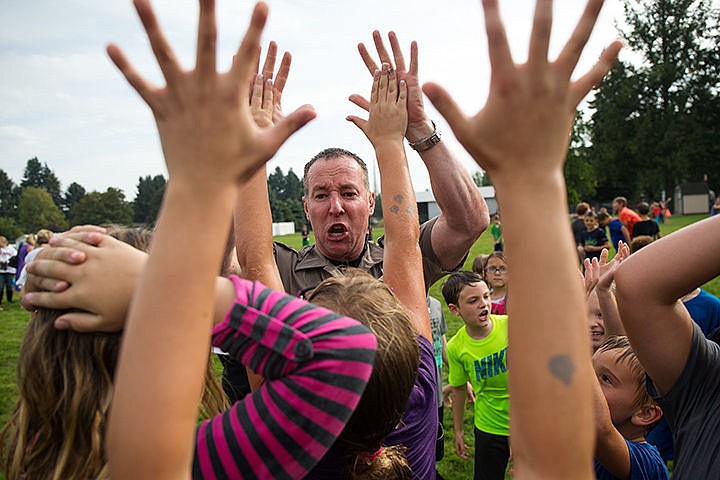 &lt;p&gt;TESS FREEMAN/Press&lt;/p&gt;&lt;p&gt;Scott Hice, from the Kootenai County Sheriff&#146;s Department high fives students at Dalton Elementary School during their ice bucket challenge. Hice is the school resource officer for Dalton Elementary School.&lt;/p&gt;