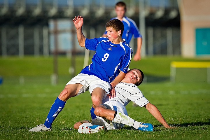 &lt;p&gt;Coeur d'Alene High's Matt Hulquist falls back onto Luke Barrett from Lake City High after passing the ball during the first half of Thursday's 1-1 draw.&lt;/p&gt;