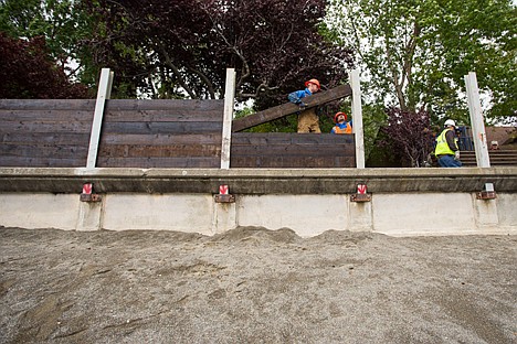 &lt;p&gt;City employees Bobby Covey, left, and Jason Hendricks work together to drop a treated timber in place Monday while installing an extension of the seawall near the Coeur d'Alene city beach. The flood control system project is being erected to qualify for Federal Emergency Management Agency certification.&lt;/p&gt;