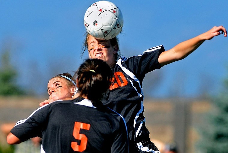 Flathead&#146;s Sarah Cummins (20) heads the ball in the first half of Thursday afternoon&#146;s Western AA crosstown soccer match at Glacier High.