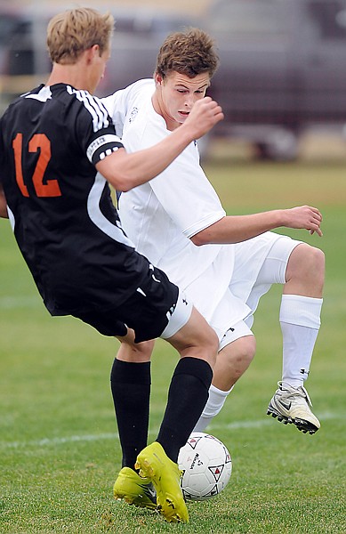 <p>Glacier junior Tanner Hart works to move the ball down field
against Flathead senior Christopher Cronk (12) during Saturdays
crosstown match at Glacier. Glacier won 8-0.</p>