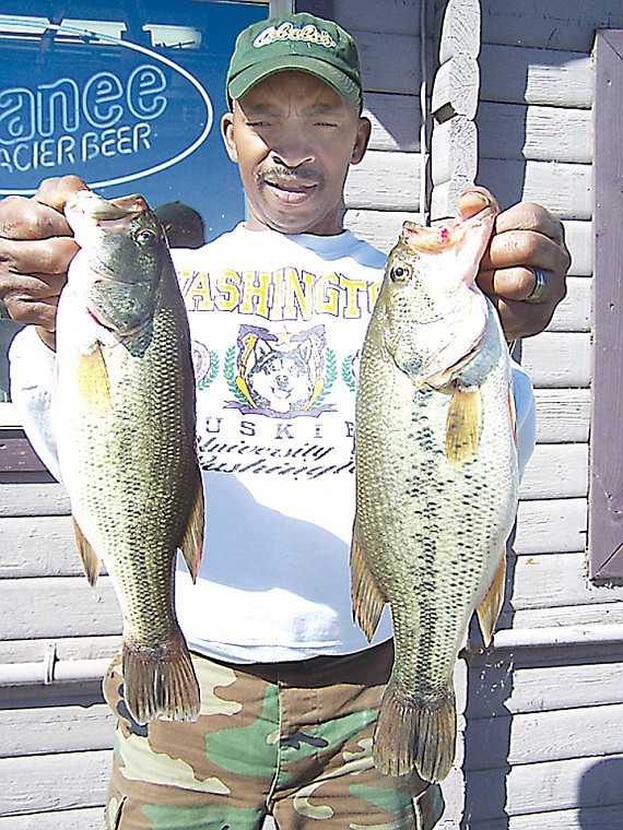 Tilden Smith, Seattle, enjoyed his first time fishing on
Potholes Reservoir. Mr. Smith shows some fine bass he landed on the
face of O'Sullivan Dam using a Yamamoto Senko.